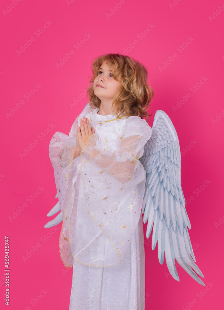Angel prayer. Angel child. Isolated studio shot. Cute kid with angel wings. Cupid with prayer hands, hope and pray concept, valentines day concept. Angel prayer. Angel child. Isolated studio shot. Cute kid with angel wings. Cupid with prayer hands, hope and pray concept, valentines day concept.