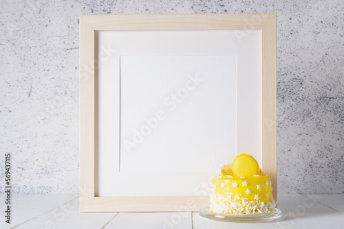White frame with space for text and a small yellow cake. Birthday, anniversary, holiday