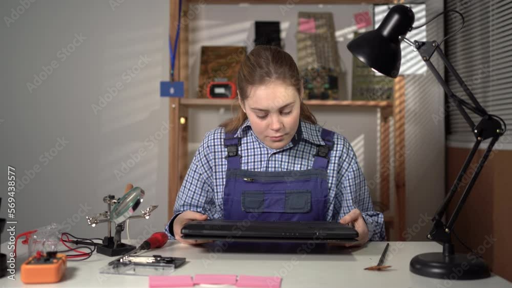 Service repair electronics. Woman make inspection laptop computer before repair Service repair electronics. Woman make inspection laptop computer before repair