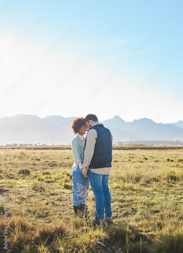 Love, interracial and couple on countryside vacation, holding hands and joyful outside with romantic view. Romance, happy man and black woman on field, holiday and weekend break, happiness or support