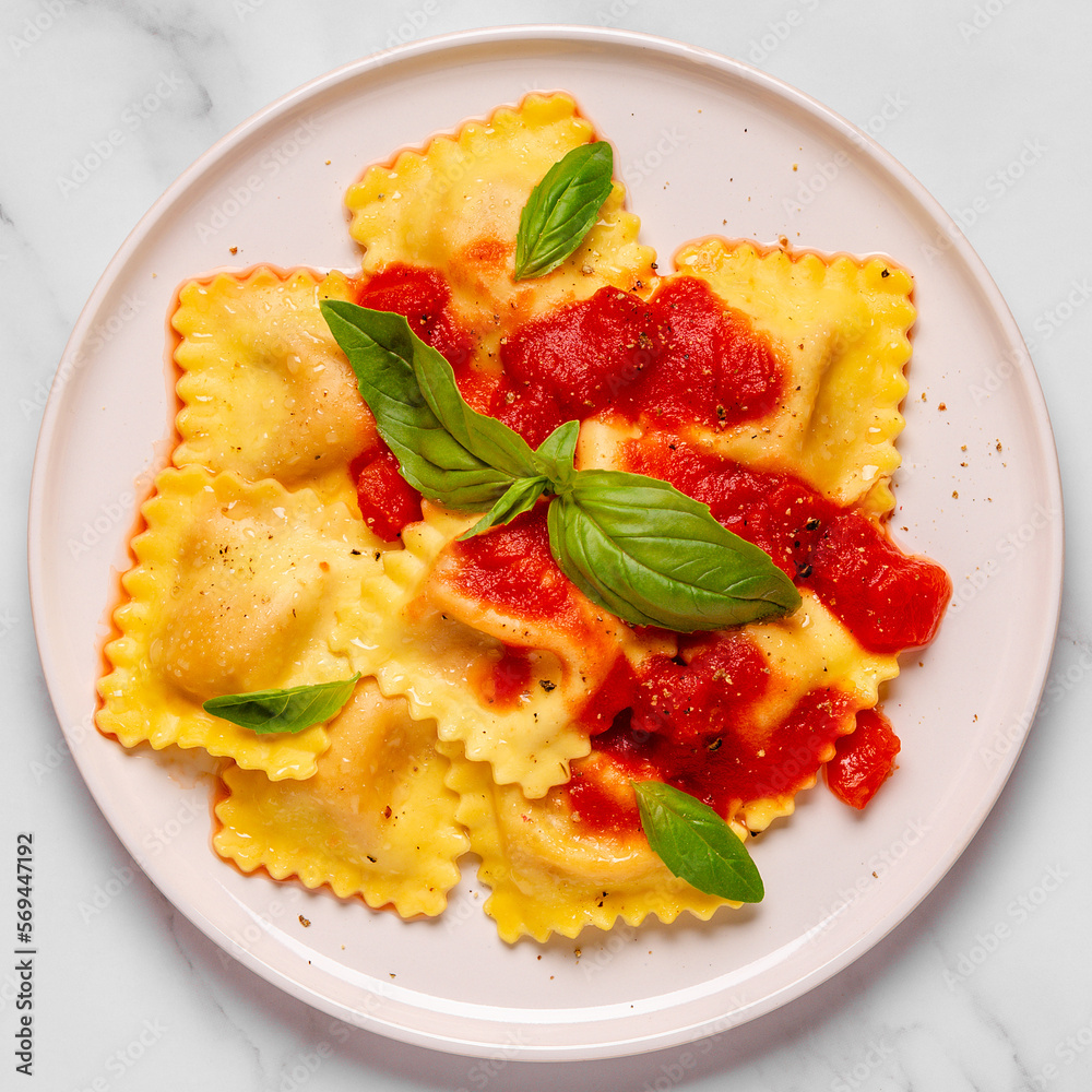 Delicious appetizing ravioli with tomato sauce and basil Delicious appetizing ravioli with tomato sauce and basil