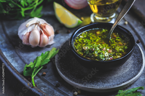 Chimichurri verde - Fresh traditional chimichurri sauce for barbecue meat photo