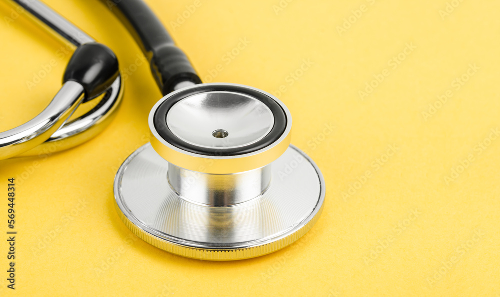 Stethoscope on a yellow background with space for text. Stethoscope on a yellow background with space for text.