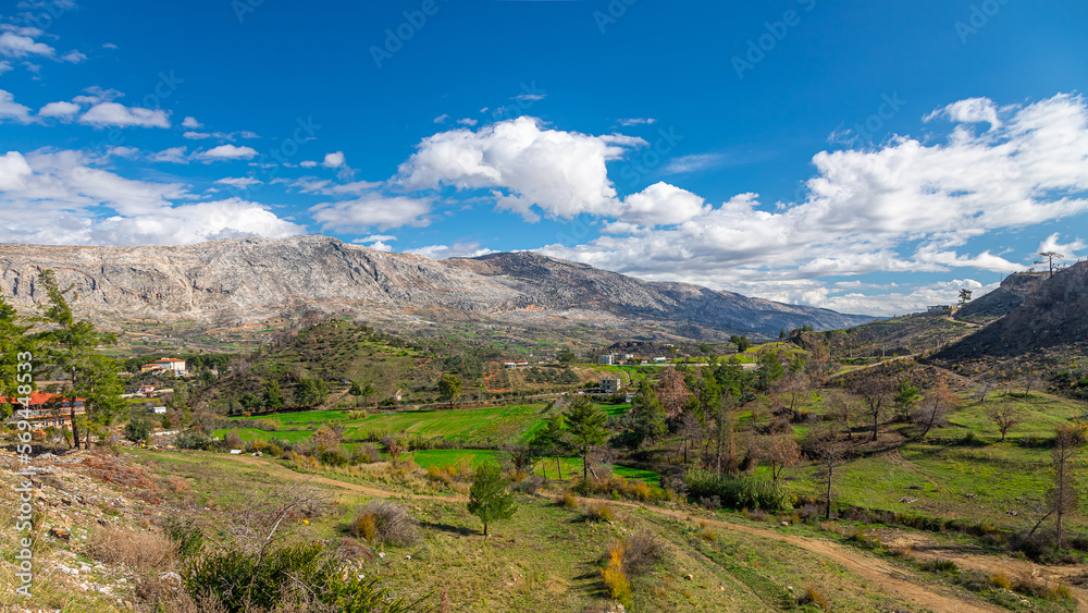 Panoramic view of a mountain river and a small village, valley. Mountain river stream landscape