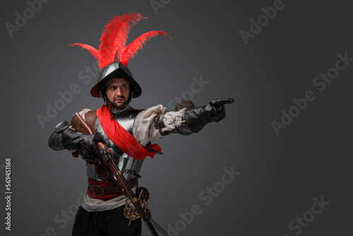 Portrait of conquistador gunslinger with flintlock rifle dressed in armor.