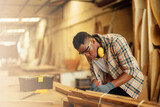 Carpenter man attend to making masterpiece woodworks handcrafted furniture fine measure in wood workshop.