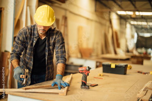 Carpenter man attend to making masterpiece woodworks handcrafted furniture fine measure in wood workshop.