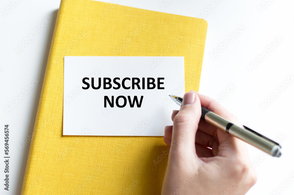 text SUBSCRIBE NOW on a white card writes a person's hand on a light background text SUBSCRIBE NOW on a white card writes a person's hand on a light background