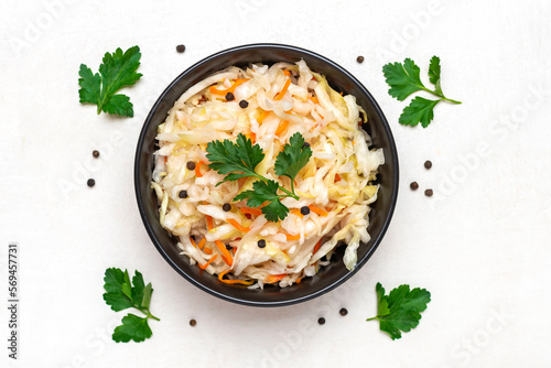 sour cabbage in wooden bowl pepper on white table Fermented vegetable concept Healthy food Top view