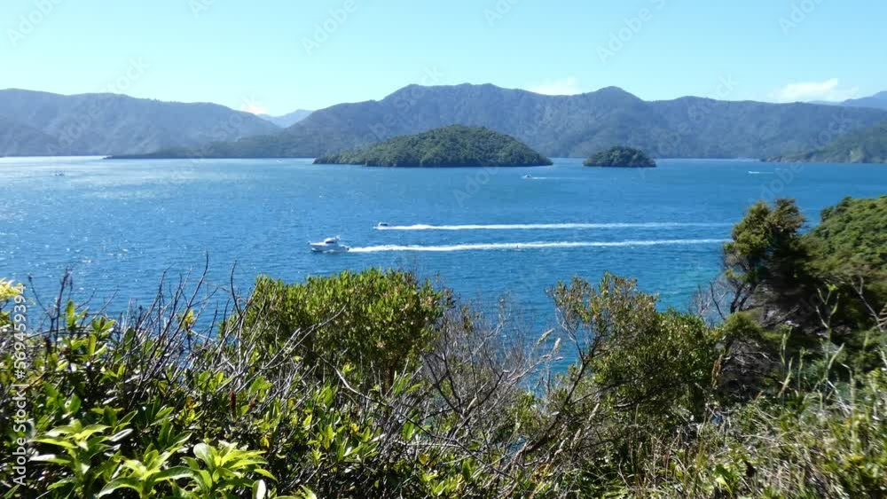 Boating activity on a beautiful deep-blue sea in summertime - Karaka Point, Queen Charlotte Sound (New Zealand) Boating activity on a beautiful deep-blue sea in summertime - Karaka Point, Queen Charlotte Sound (New Zealand)