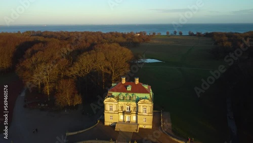 Sun shining on iconic hunting lodge building, aerial drone view photo