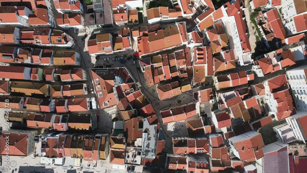 Aerial footage of village from above full of building ceilings