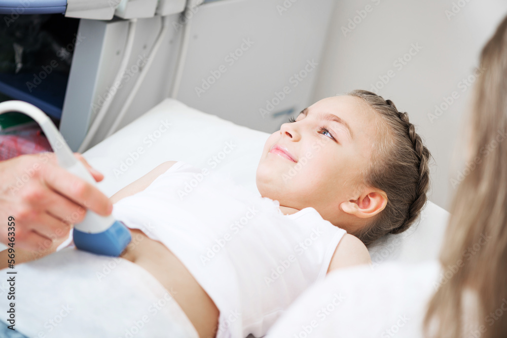 Doctor ultrasound examines little patient belly