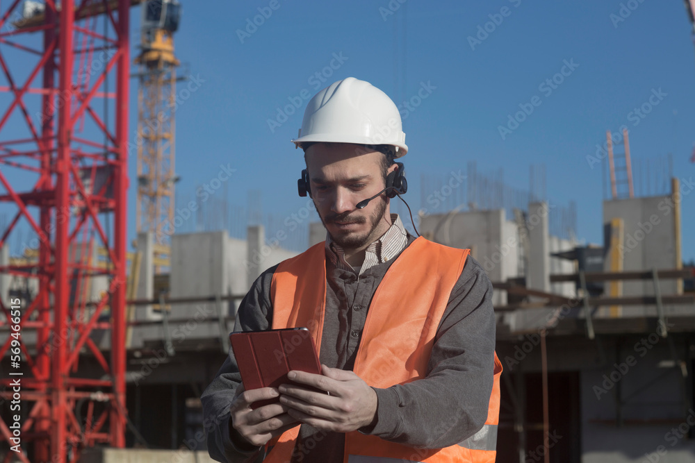 Young male engineer using digital tablet at construction site, Freiburg Im Breisgau, Baden-Württemberg, Germany Young male engineer using digital tablet at construction site, Freiburg Im Breisgau, Baden-Württemberg, Germany