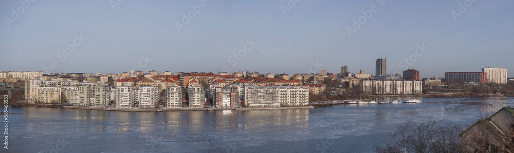 Panorama, view from the hill Ormberget over the districts Essingen islands and Kungsholmen, waterfront apartments at a bay of the Mälaren se, a sunny snowy winter day in Stockholm