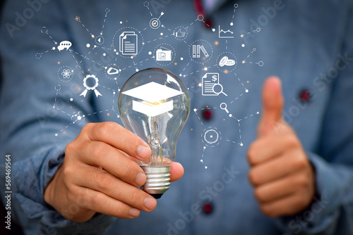 E-learning Education Internet Technology Webinar Online Courses concept. hand holding lightbulb showing graduation hat,