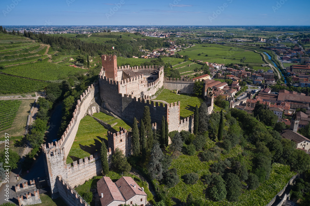 View of Soave castle surrounded by vineyard plantations. Soave castle aerial view Verona province, Italy. Ancient castle on a hill in Italy.