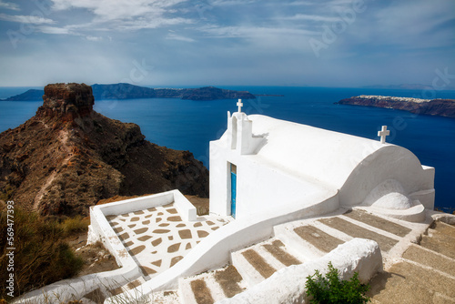 Small Chapel on the Walking Path to Skaros Rock at Imerovigli, with a Distant View of Oia, Santorini, Greece