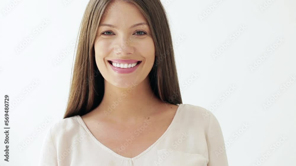 Studio shot of a pretty Caucasian woman smiling. Studio shot of a pretty Caucasian woman smiling.
