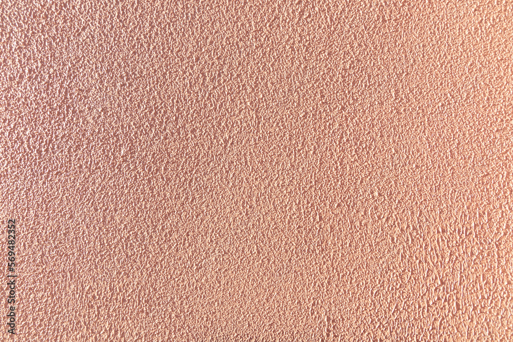 Fototapeta premium Textured pink wall, very rough to the touch.
