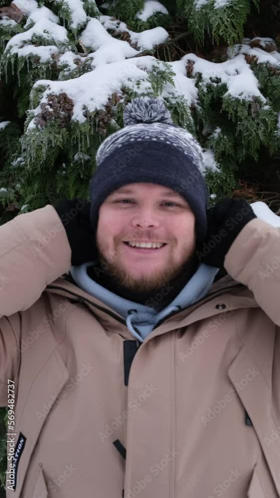 happy handsome man get on winter hat