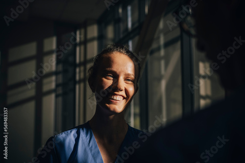 Sunlight falling on face of happy nurse in hospital
