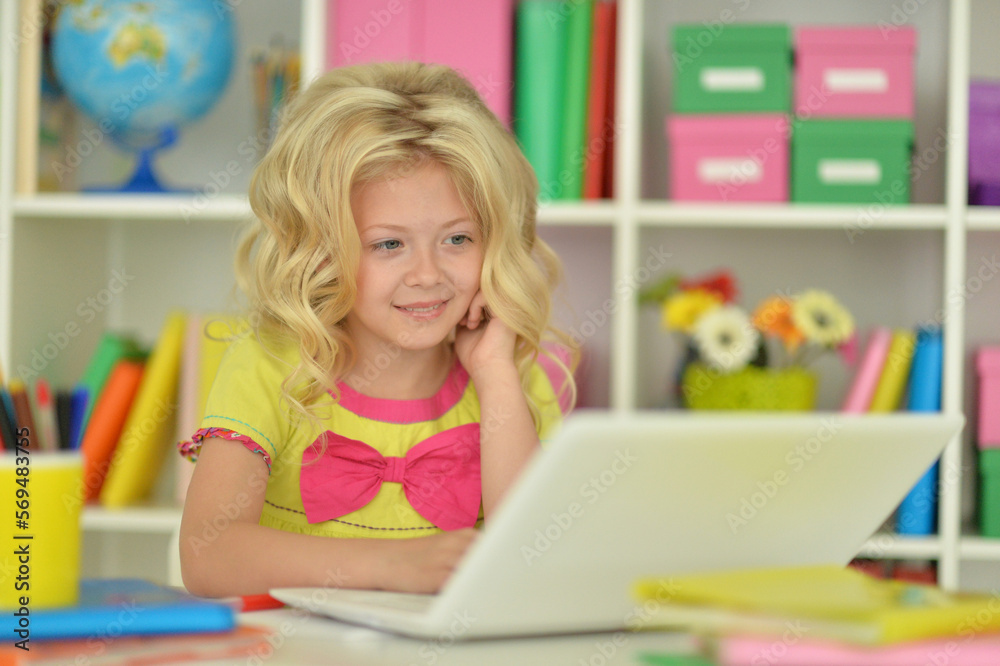 girl using laptop at desk at home girl using laptop at desk at home