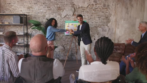 happy businesswoman gets applause from her colleagues - an employee of the month nominee after brainstorming photo