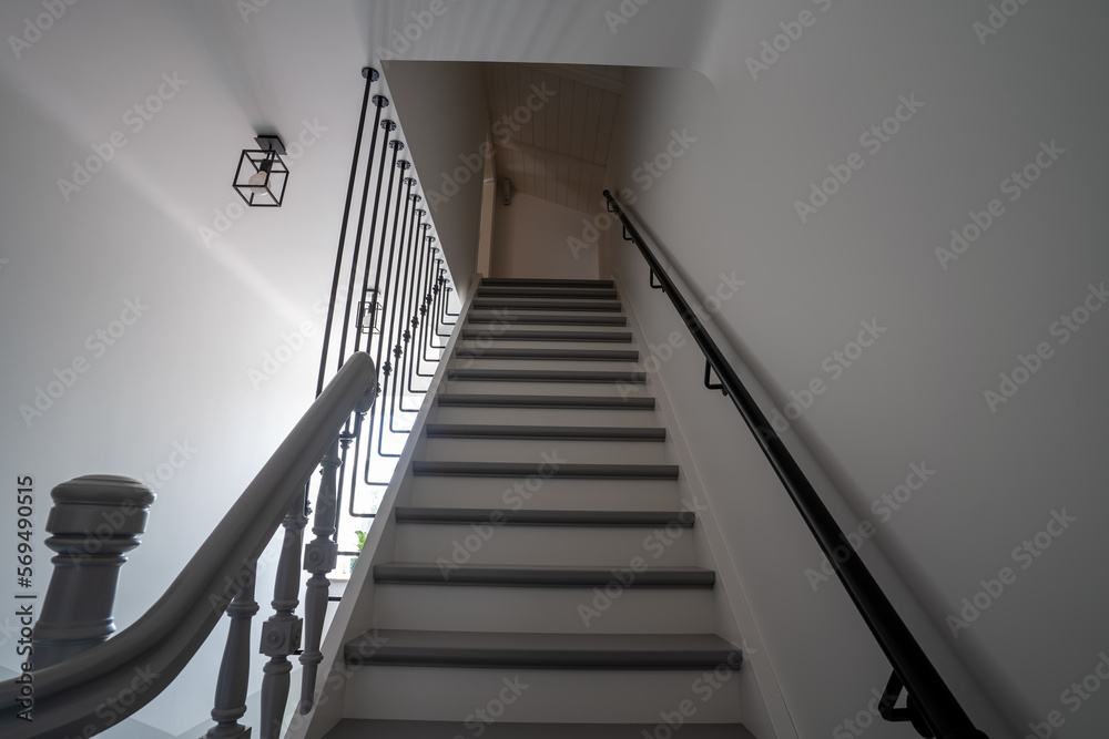 Close up on a railing leading down a grand winding staircase. Close up on a railing leading down a grand winding staircase.
