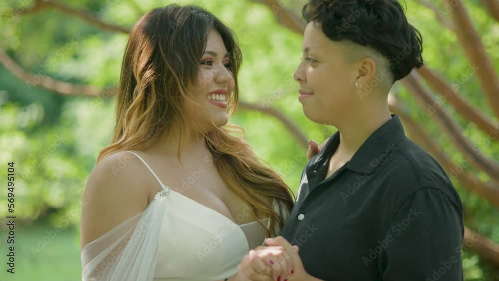 Outdoor Summer Wedding. Beautiful Happy Same-Sex Couple Laughing and Smiling in Love on Wedding Day. Marriage Equality LGBTQ+ Outdoor Summer Wedding. Beautiful Happy Same-Sex Couple Laughing and Smiling in Love on Wedding Day. Marriage Equality LGBTQ+