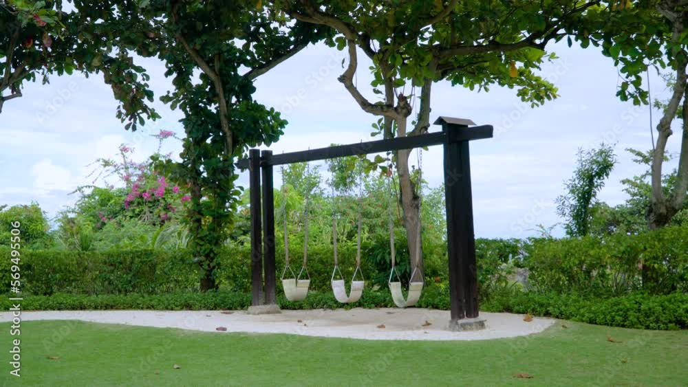Empty Swings On The Meadow Green Garden In The Resort Of Shangri-La Mactan, Cebu, Philippines. Static Shot
Empty Swings On The Meadow Green Garden In The Resort Of Shangri-La Mactan, Cebu, Philippines. Static Shot