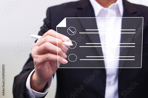 Businessman working on a digital document on a virtual screen using a stylus pen. Concept of Technology and future document management.