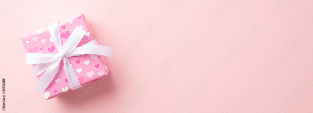 Gender reveal party concept. Top view photo of pink giftbox with white ribbon bow on isolated pastel pink background with copyspace Gender reveal party concept. Top view photo of pink giftbox with white ribbon bow on isolated pastel pink background with copyspace