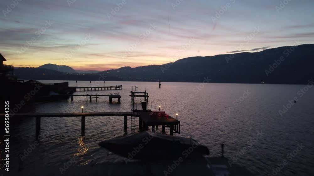 drone shot of kelowna city beach docks on Okanogan lake with sunset drone shot of kelowna city beach docks on Okanogan lake with sunset