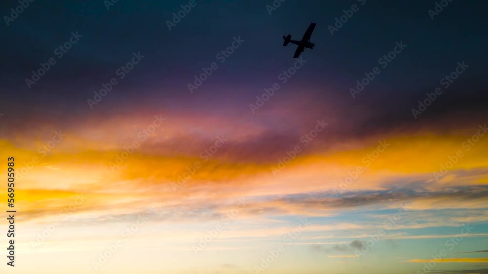 a plane flying under clouds at sunset a plane flying under clouds at sunset