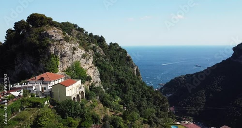 The remote settlement aerial view with rugged mountains. Rural terrace farming on a hilly landscape, drone footage. Aerial view of mountains nearby the Ocean. Positano landscape. Italy, Amalfi Coast. photo