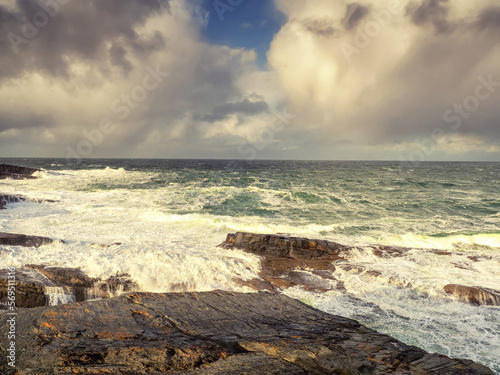 Spectacular Irish seascape with rough stone coast line and powerful Atlantic ocean. Kilkee area, Ireland. Dramatic sky. Detailed nature scene.