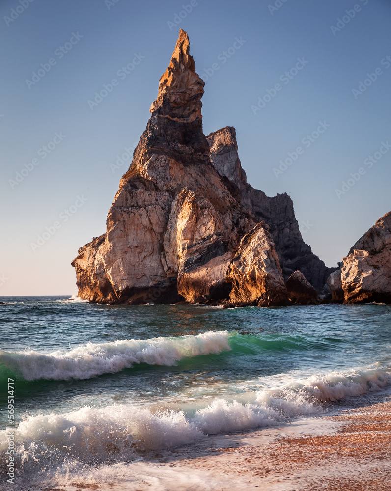 Naklejka premium Praia da Ursa in summer with waves and rocks