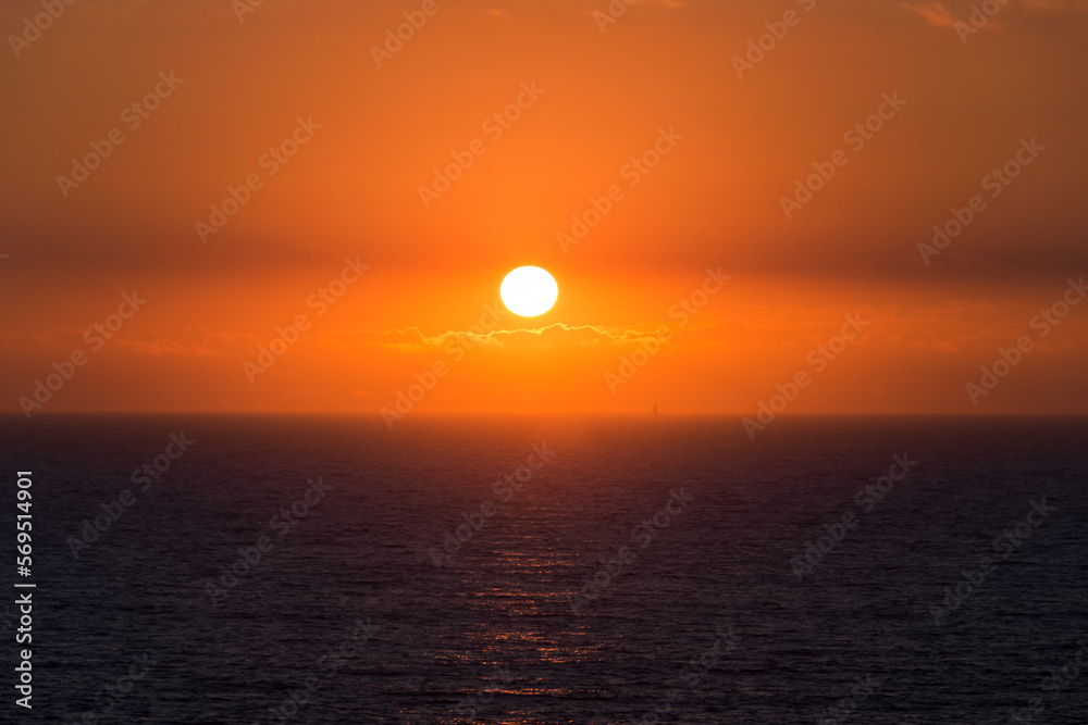 Sunset over Ocean and boat on the horizon Sunset over Ocean and boat on the horizon