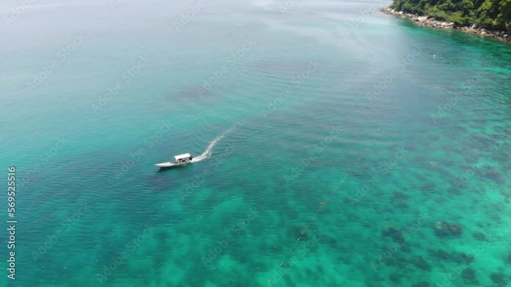 Drone view of a boat moving forward on Perhentian Island Drone view of a boat moving forward on Perhentian Island