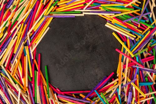 Colourful matchsticks with circle in the middle empty for your text