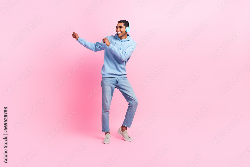 Full length photo of overjoyed man wear blue trendy clothes celebrate shopping sale look empty space isolated on pink color background Full length photo of overjoyed man wear blue trendy clothes celebrate shopping sale look empty space isolated on pink color background