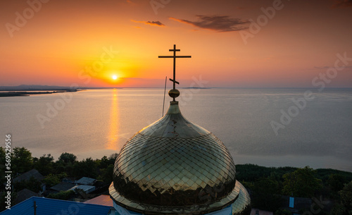 Orthodox lipovan church during sunrise next to a lake in Dobrogea Sarichioi village. Landmarks of Romania.