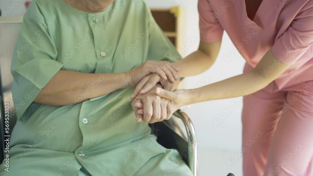 Woman nurse hands check up body of sick old senior elderly patient sitting on wheelchair in hospital in medical and healthcare treatment. Asian Thai people lifestyle. Family encourage. Woman nurse hands check up body of sick old senior elderly patient sitting on wheelchair in hospital in medical and healthcare treatment. Asian Thai people lifestyle. Family encourage.