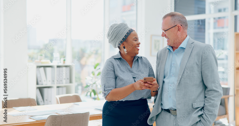 Obraz premium Woman, phone and businessman for social media, laughing and funny meme in finance office. Happy senior executive, black woman and smartphone for joke, social network or conversation on lunch at work