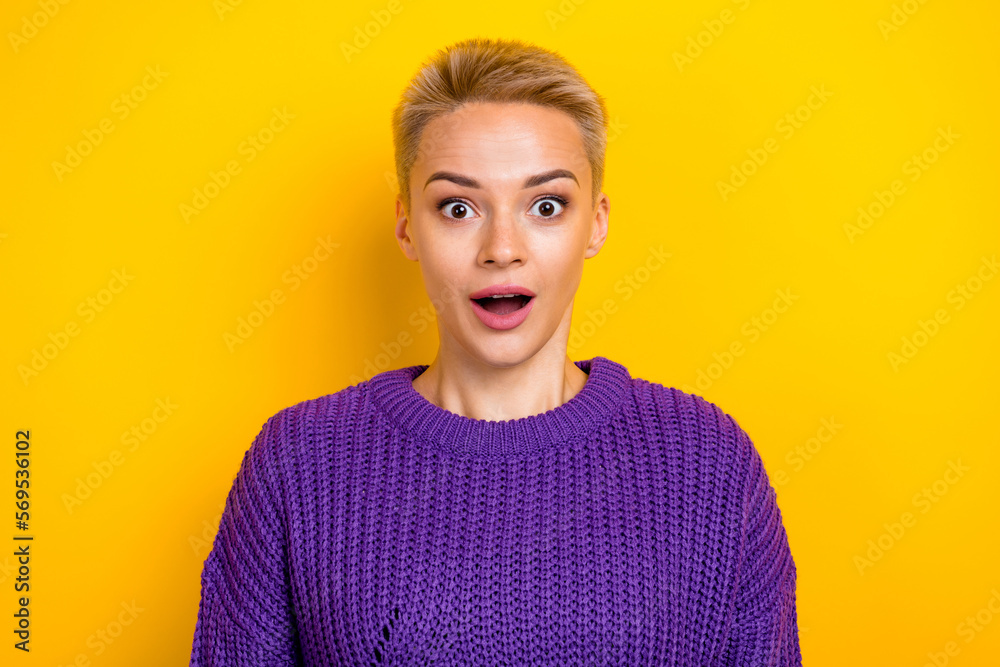 Portrait of young attractive blonde short hair woman open mouth surprise wear purple knitted sweater black friday isolated on yellow color background Portrait of young attractive blonde short hair woman open mouth surprise wear purple knitted sweater black friday isolated on yellow color background
