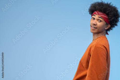 Positive dark-haired young man looking contented