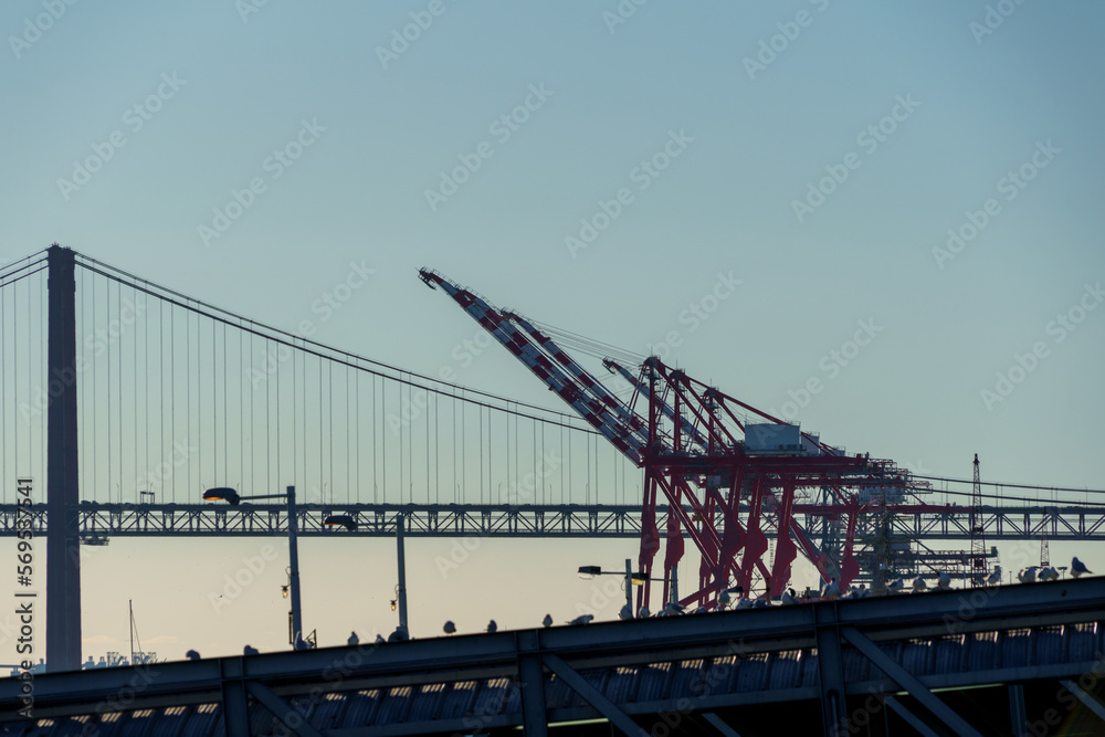 gantries and cranes lining the harbour warf awaiting cargo