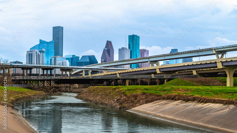 Houston Downtown City Skyline and water reflections along the White Oak Bayou Greenway under Interstate 45 Freeway in Texas, USA Houston Downtown City Skyline and water reflections along the White Oak Bayou Greenway under Interstate 45 Freeway in Texas, USA