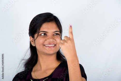 A indian young girl show her ink-marked fingers after casting vote in election.